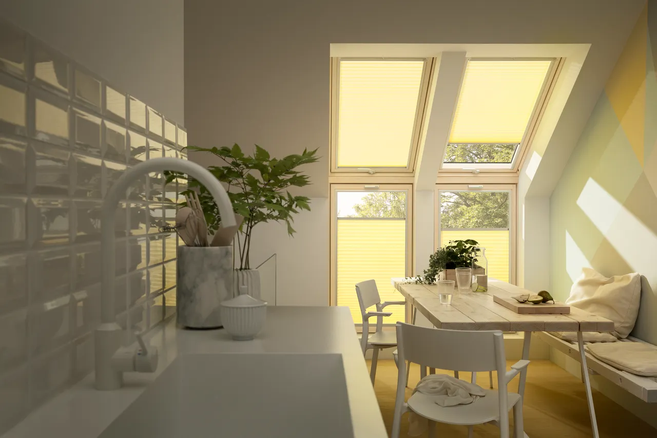 A room with a table, chairs and a window.