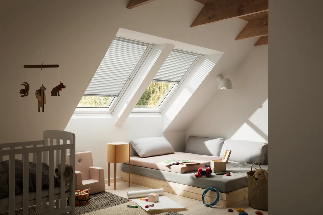 A small child's room with a bed and a crib.